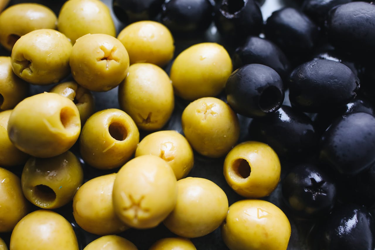 Close-up of green and black olives, showcasing glossy texture and natural color.