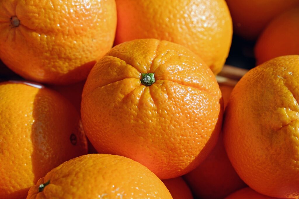 Close-up of fresh oranges with textured peels.