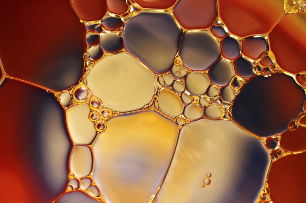 Close-up of oil bubbles, showing different shades and patterns.