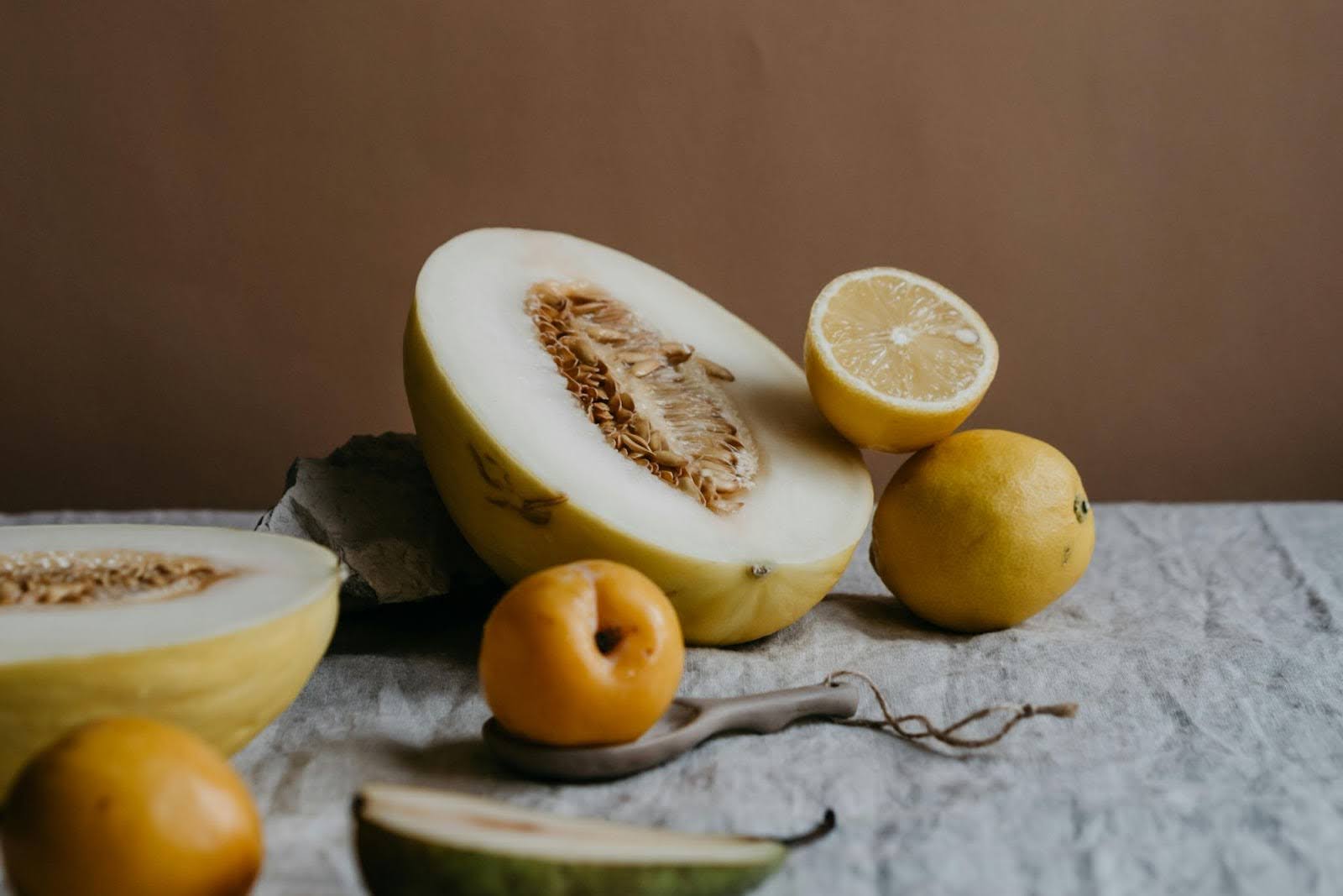 A sliced melon with other fruits.