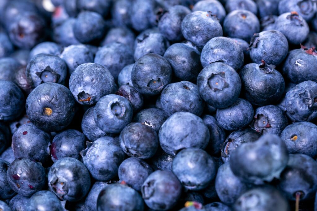 A close-up of ripe blueberries, showcasing their rich blue-purple color and natural texture.