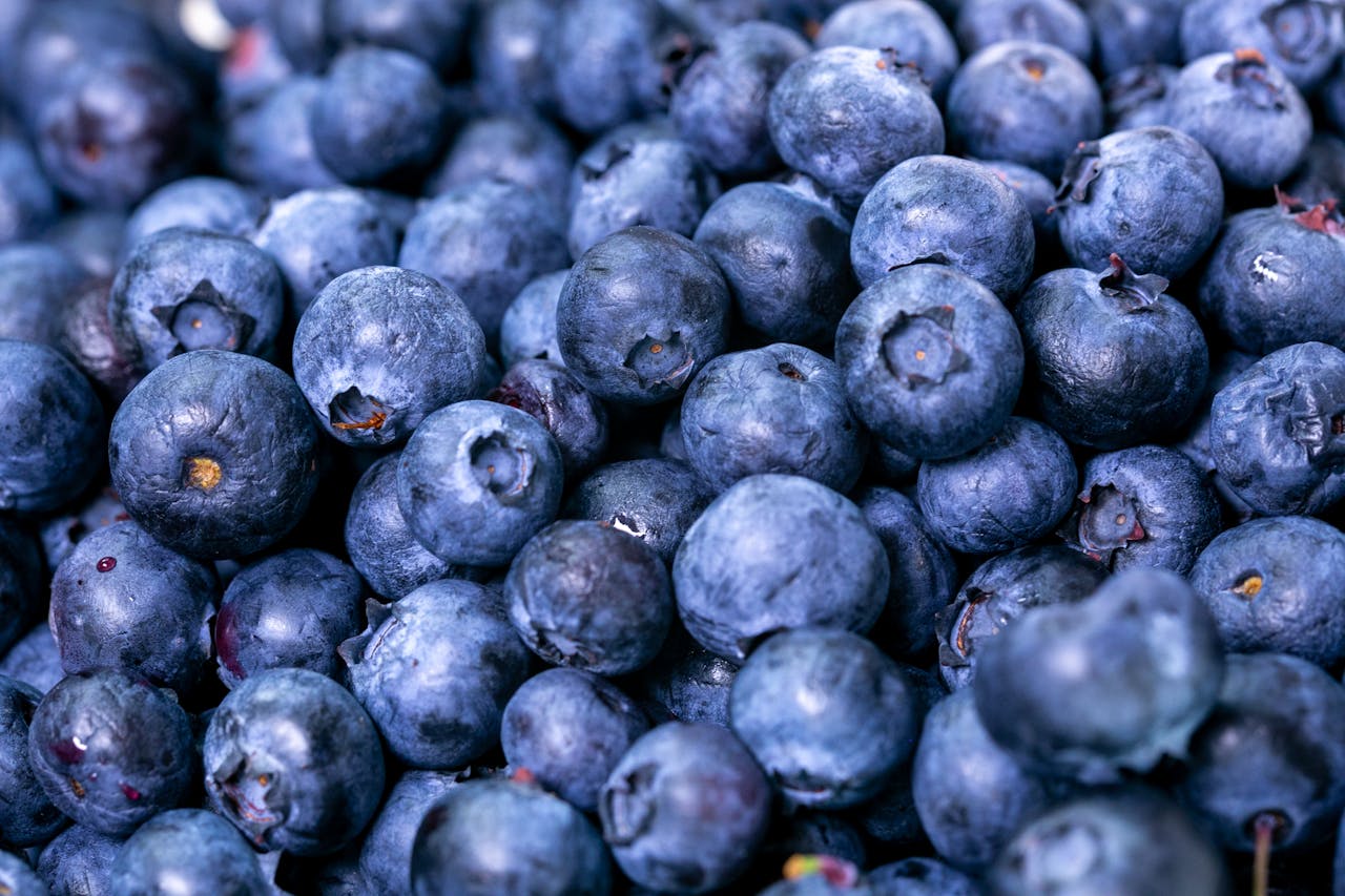 A close-up of ripe blueberries, showcasing their rich blue-purple color and natural texture.