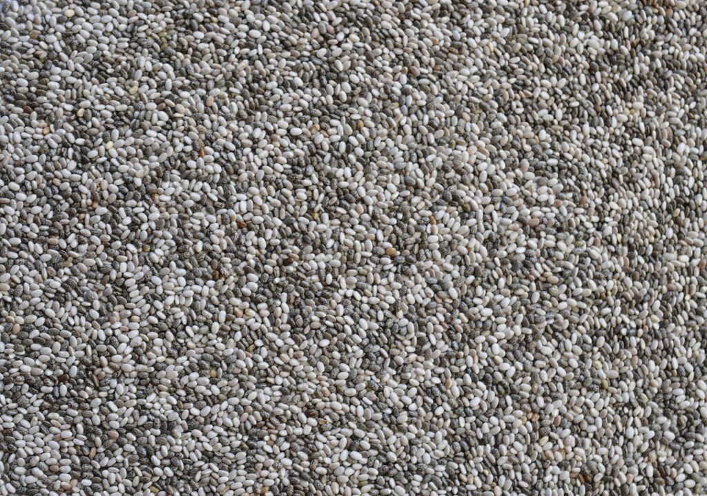 Close-up of chia seeds scattered in a large pile.